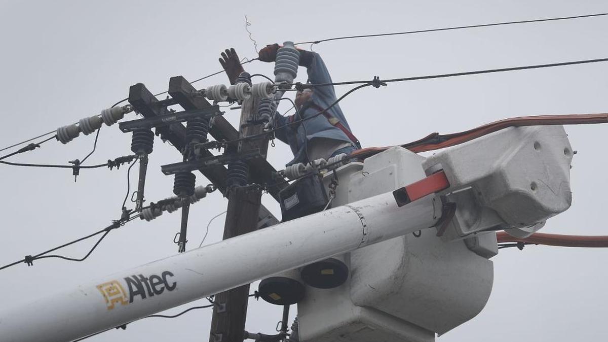 Un trabajador repara el viernes un tendido eléctrico en Fort Pierce, tras el paso del huracán Matthew.