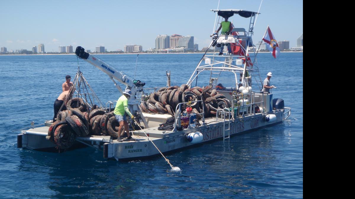 
Un bote lleno de las llantas removidas del fondo del mar.
