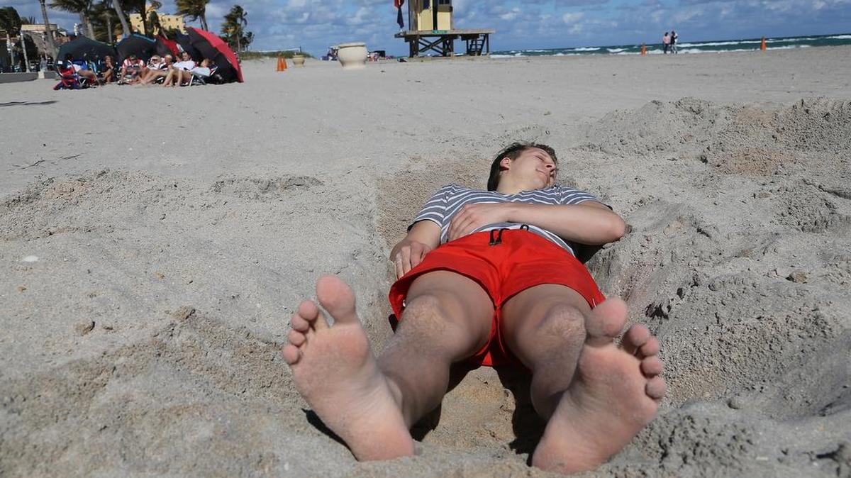 Canadian Sam Gaudreau basks in the sun on Hollywood Beach in January 2018.
