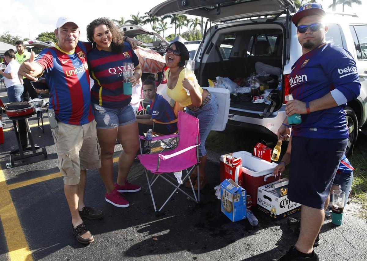 Aficionados del FC Barcelona posan con las camisetas del equipo el sábado 29 de julio de 2017, antes del partido que enfrentará al Real Madrid contra el FC Barcelona, en el Estadio Hard Rock, en Miami. El clásico en Miami ha reunido a aficionados al fútbol de todo Estados Unidos y Latinoamérica, que llegan al sur de Florida después de ahorrar mucho para vivir esta fiesta. Es el segundo clásico de la historia que se disputa fuera de España y el primero en Estados Unidos, así que a pesar de tratarse de un partido amistoso, la locura por azulgranas y merengues ha invadido Miami.