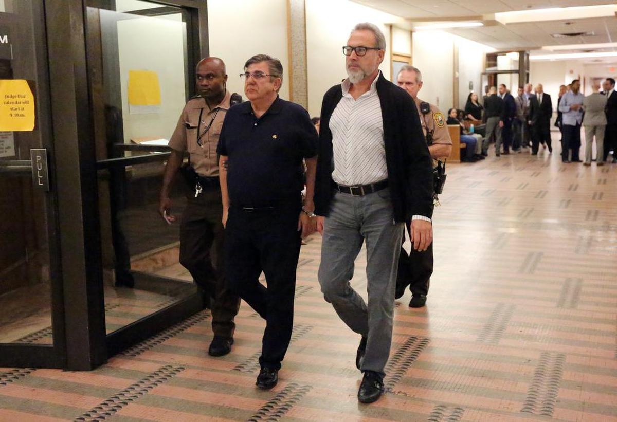 Alejandro Sanchez del Arco, regional manager for the Caribbean for RIU, left, and Luis Riu Guell Jr., CEO and owner of the RIU Hotel & Resort chain, surrendered in Judge Jorge Cueto’s Miami courtroom Monday morning, Feb. 12, 2018, to face allegations they gave free hotel stays to a Miami Beach city official in exchange for help with building permits. The two RIU executives were handcuffed in court and led away to be booked into jail where they both could post bond.