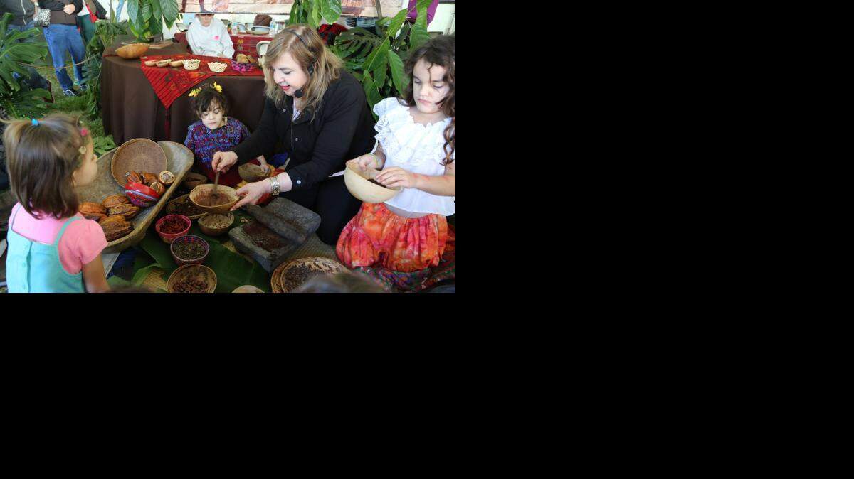 
La doctora Maricel Precilla, experta en frutas tropicales del Fairchild Tropical Garden muestra a los niños la manera artesanal con que los nativos americanos fabricaban en chocolate. 
