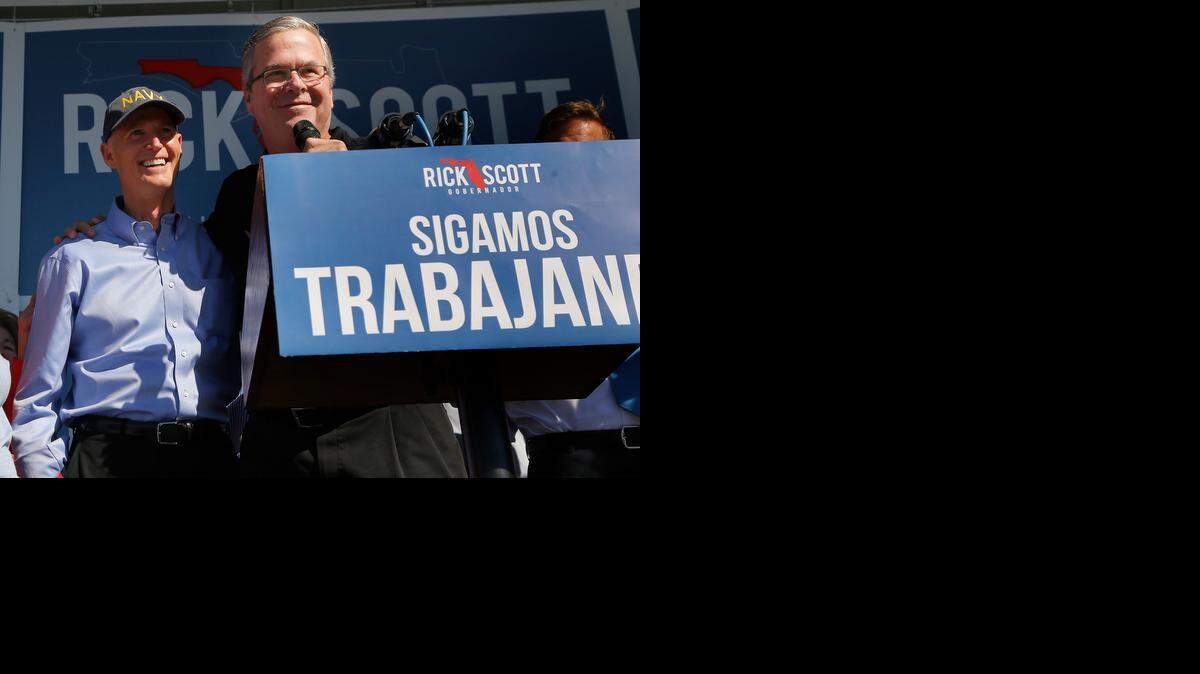 
Jeb Bush, acompaña al gobernador Rick Scott (izq.), en su cierre de campaña en Hialeah, el domingo. 

