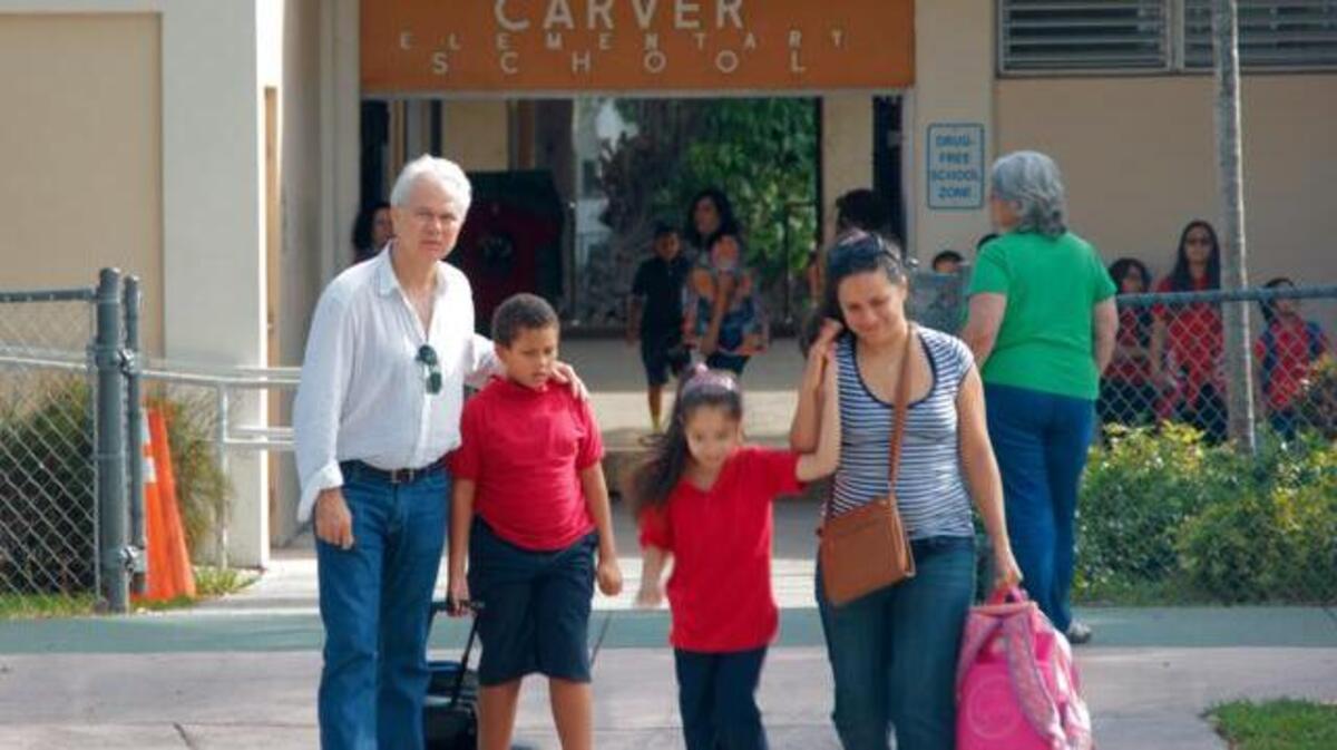 
Parents picking up children at George Washington Carver Elementary School on Grand Avenue. The school is located across the street from a controversial new Wawa gas station and convenience store, but construction has paused.


