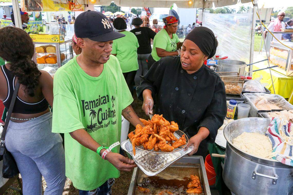 Chef Michelle Risher of New York takes chicken out of the frier during the 2021 Miami Carnival.