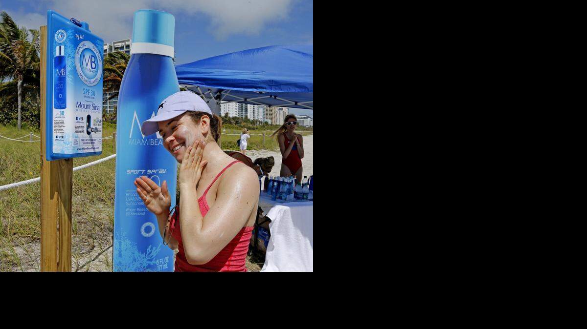 
Rachel Gerber, de Nueva York, se aplica bloquedor solar gratis en una playa de Miami Beach.
