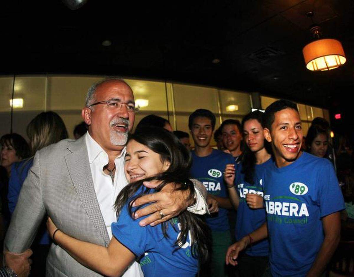 Ronald Reagan School student hugs candidate Peter Cabrera upon learning of his victory against Bettina Rodríguez-Aguilera for the position of Doral city councilor, at the Braseros restaurant in the city of Doral on Tuesday, November 4, 2014 .