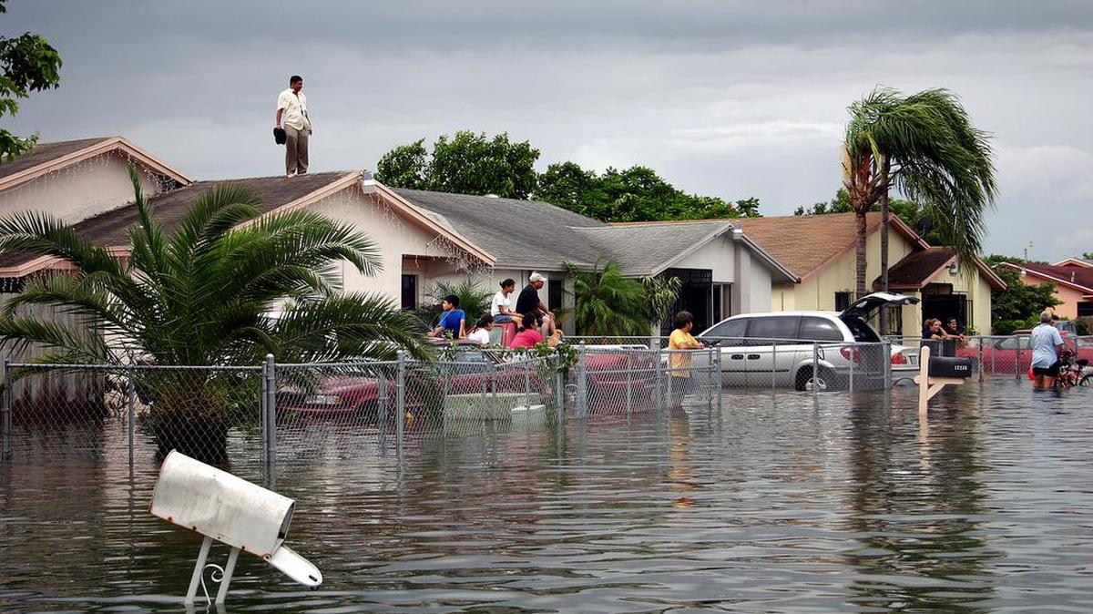 Above: Neighbors in Perrine, in southeast Miami-Dade County, inspect their homes after Hurricane Katrina passed South Florida in August 2005.