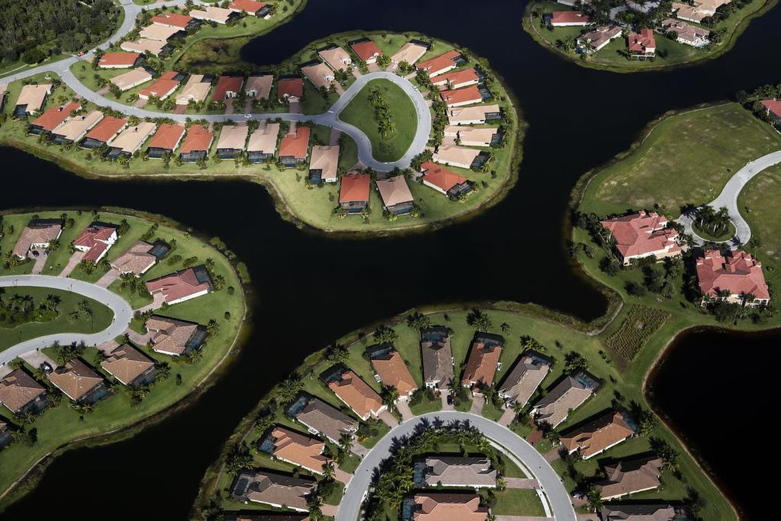 In this Thursday, Oct. 24, 2019, photo, a housing development built in Everglades wetlands is seen from the air near Naples, Fla. (AP Photo/Robert F. Bukaty)