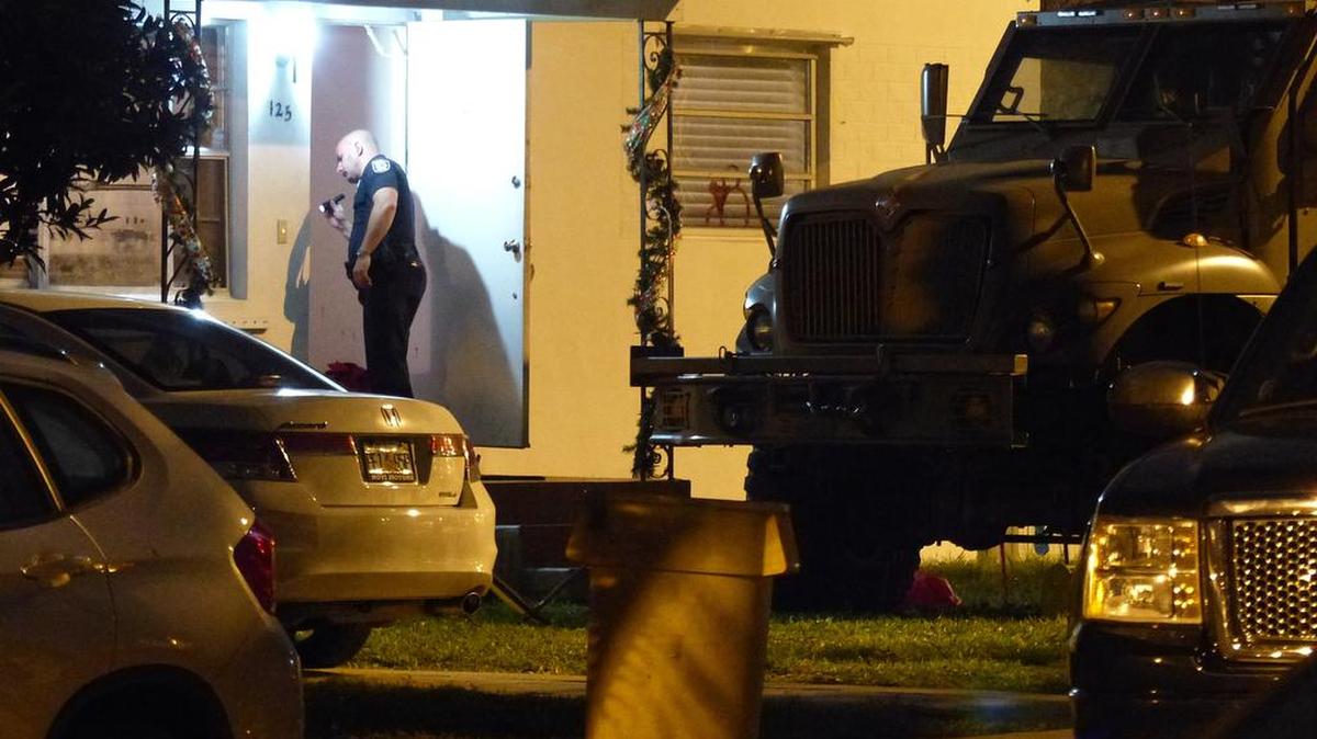 Police surround a house at 125 W. 56th Street in Hialeah where a man had barricaded himself on Wednesday, Dec. 23, 2015.