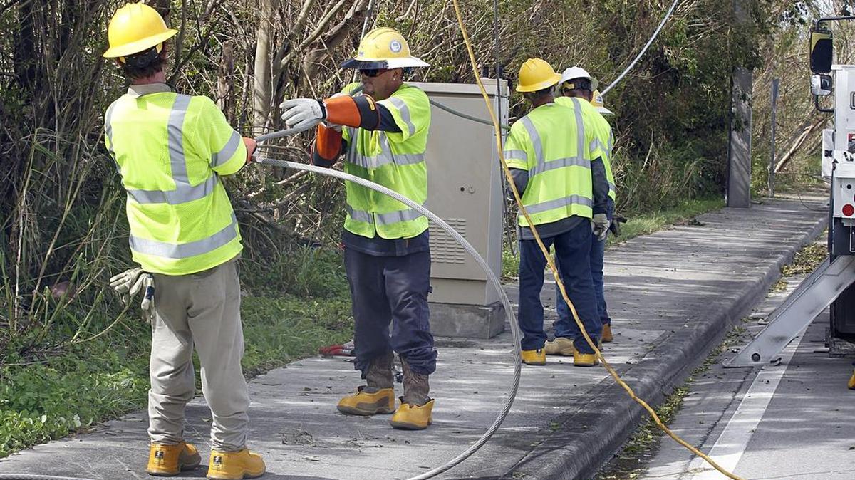 Linieros con la compañía de Pike, que trabajaba con FPL, tratan de conectar una línea eléctrica principal en la intersección de la avenida 37 y de la calle 140 en Kendall, un día después de que el huracán Irma saliera del sur de la Florida, el 11 de septiembre de 2017.