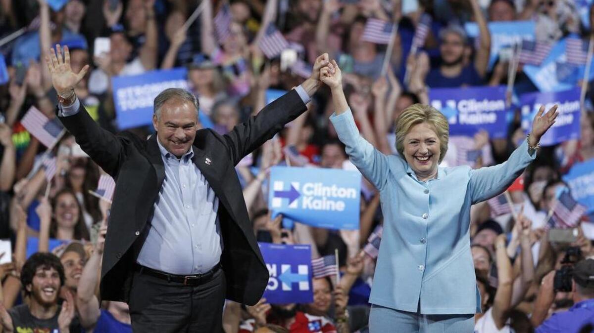 La candidata presidencial demócrata Hillary Clinton y el senador Tim Kaine, de Virginia, suben al escenario en un acto en la Universidad Internacional de la Florida de Miami, el sábado 23 de julio de 2016. Es el primero acto en el que ambos aparecen en público desde que Clinton anunciara a Kaine como su compañero de fórmula.