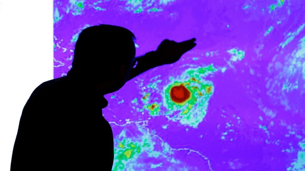
El meteorólogo James Franklin examina la imagen de la tormenta Tropical Erika cuando aún estaba al este de las Antillas Menores.
