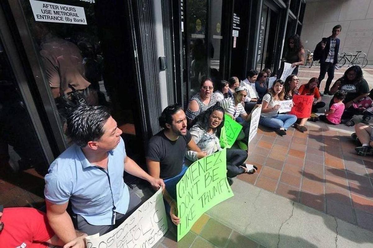 Protesters gathered in January 2017 outside Miami-Dade's County Hall over Mayor Carlos Gimenez's decision to reverse policy and begin accepting requests by immigration authorities to extend detentions of people in county jails on unrelated charges while being sought for deportation.