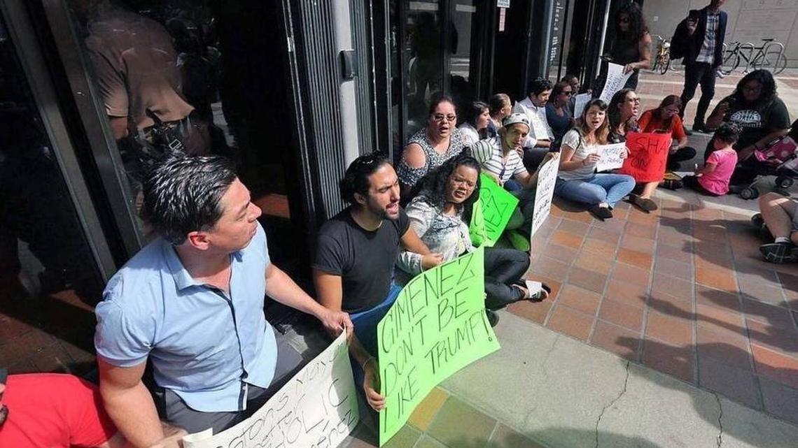 Protesters gathered in January 2017 outside Miami-Dade's County Hall over Mayor Carlos Gimenez's decision to reverse policy and begin accepting requests by immigration authorities to extend detentions of people in county jails on unrelated charges while being sought for deportation.