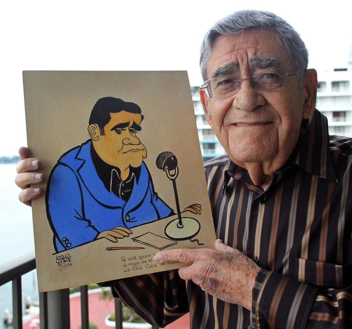 Rafael “Felo” Ramírez, legendario narrador deportivo y voz en español de los Miami Marlins, muestra una caricatura el 9 de diciembre de 2010.