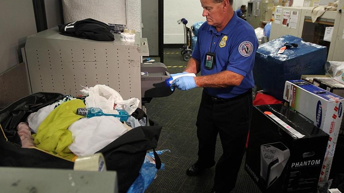 Un agente inspecciona varias maletas en el Aeropuerto Internacional de Miami. Foto de archivo.