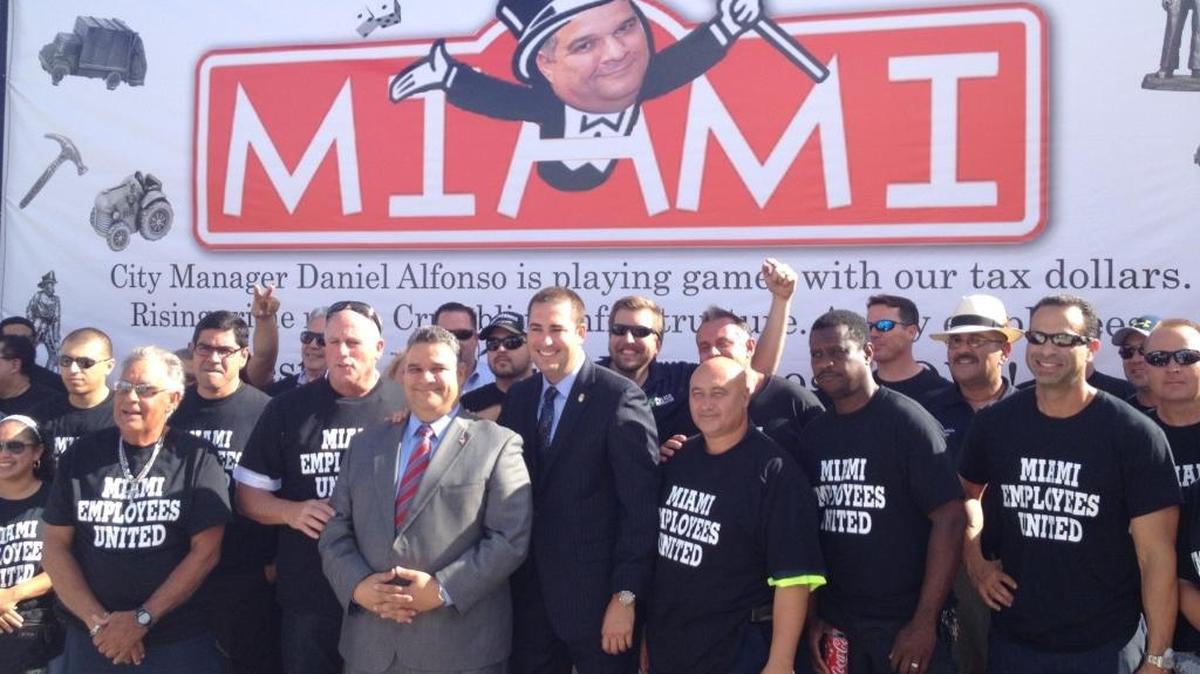El administrador de Miami, Daniel Alfonso (con traje gris), en octubre del 2014 junto a Javier Ortiz, presidente del sindicato de policías.