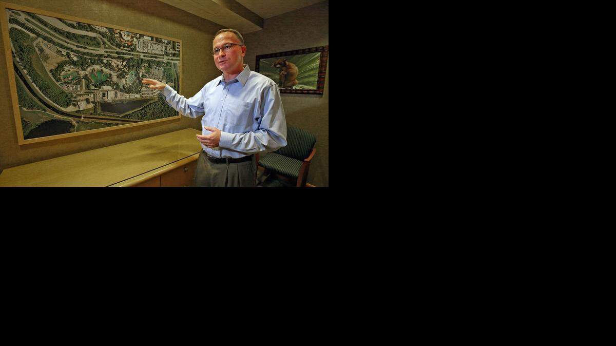 
El presidente de SeaWorld, Jim Atchinson, junto a una foto aérea de Discovery Cove en agosto. Atchinson se ha separado del puesto y ahora estará en funciones de asesor.


