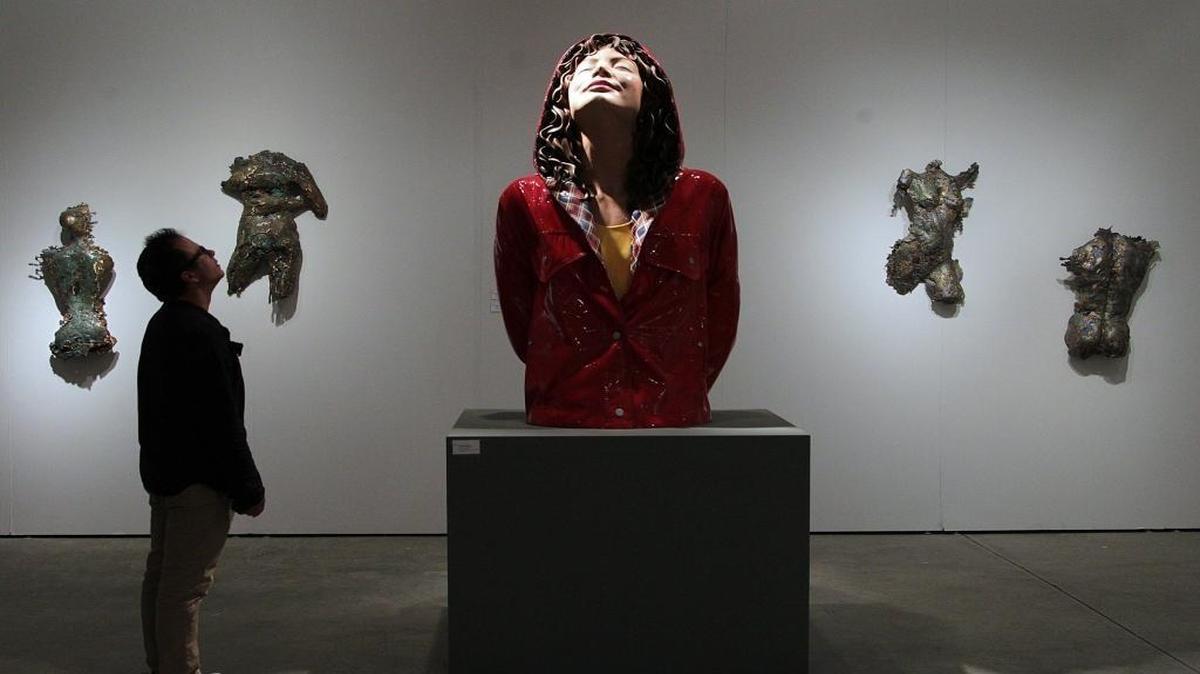 Carlos Lamas observa una pieza de Carole Feuerman en Art Miami.