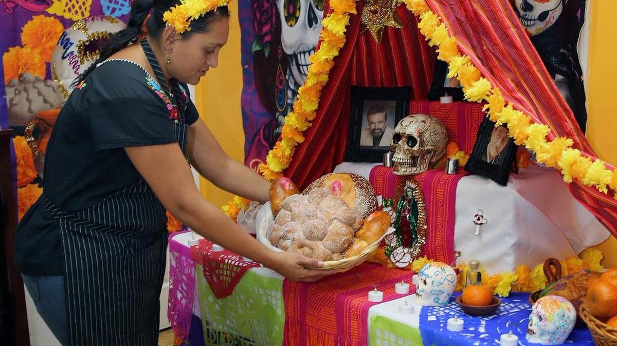 La chef mexicana Jocelyn Mendoza coloca “pan de muerto” en el altar del Día de Los Muertos del restaurante Mi Rinconcito Mexicano, en La Pequeña Habana. La tradición se celebra el 1 y 2 de noviembre. Los altares son dedicados a los seres queridos fallecidos.