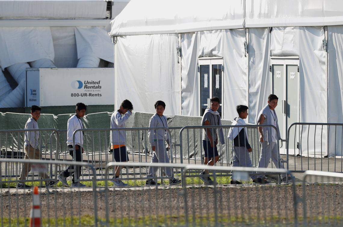 Minors line up to enter a tent at the Homestead Temporary Shelter for Unaccompanied Children in Homestead, Fla., in February 2019.
