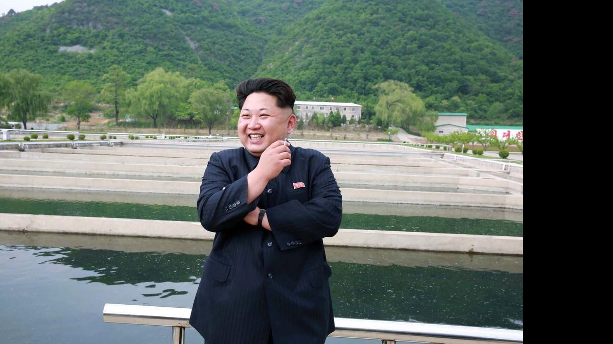 
El líder norcoreano Kim Jong Un fuma un cigarrillo durante su visita un criadero de peces administrado por el ejército norcoreano, en una imagen sin fechar distribuida el viernes 15 de mayo. 
