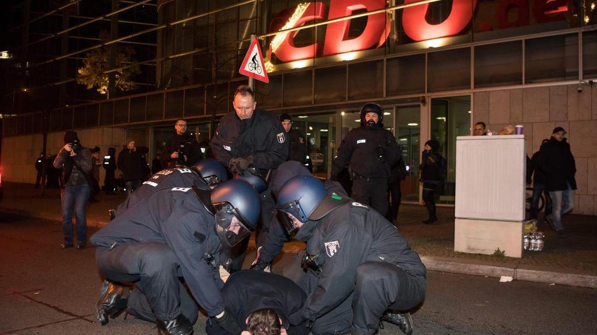 Miembros de la policía antidisturbios arrestan a un hombre durante la vigilia que extremistas de la derecha realizan el miércoles 21 de diciembre de 2016, frente a la Cancillería alemana en Berlín (Alemania). Los activistas lanzan acusaciones de complicidad en el ataque terrorista del 19 de diciembre de 2016 en un mercado navideño de Berlín a la canciller alemana Angela Merkel.