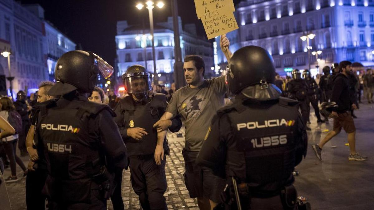 Miembros de la policia nacional desalojan a los manifestantes que se han concentrado esta tarde en la puerta del Sol de Madrid en apoyo al referéndum de Cataluña.