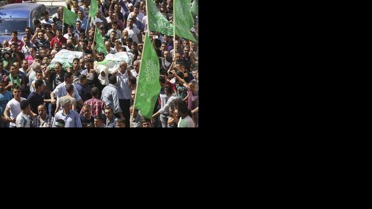 
Palestinos cargan los cuerpos sin vida de los militantes de Hamas Marwan Qawasmeh y Amar Abu Aisha durante su funeral, el martes, en Hebrón, Palestina.
