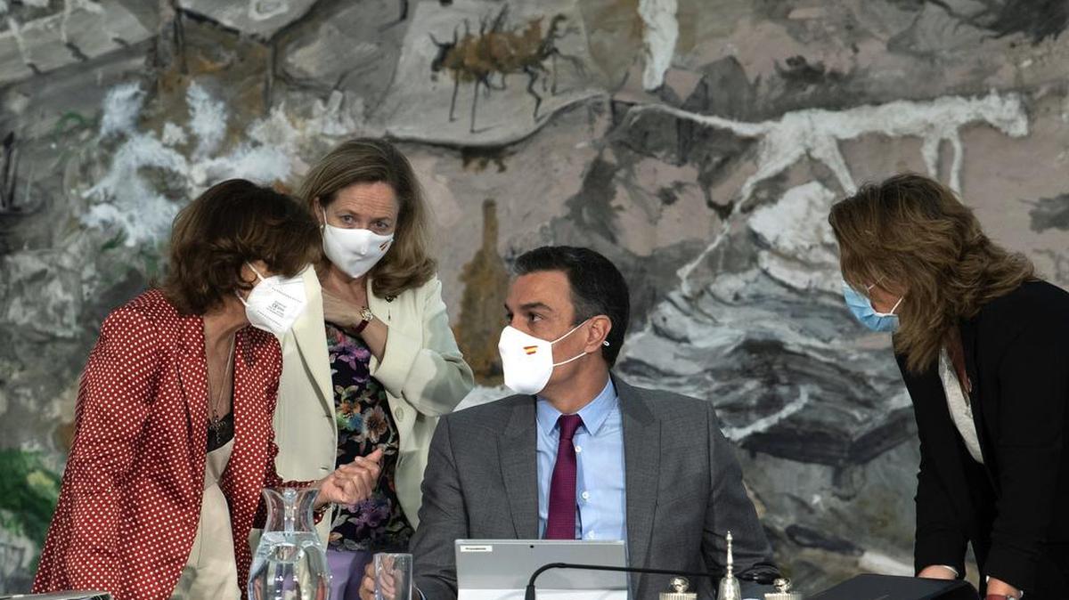 El presidente del gobierno español Pedro Sánchez conversa con la vicepresidenta primera, Carmen Calvo, izquierda, durante una reunión del gabinete en el Palacio de la Moncloa en Madrid, el 22 de junio del 2021.