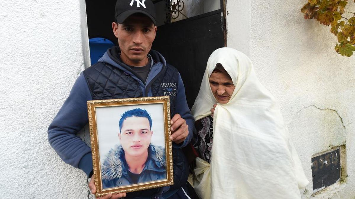 Walid Amri, hermano de Anis Amri, el principal sospechoso del ataque de Berlín, posa con su retrato en el pueblo de Oueslatia, Túnez, el 23 de diciembre.