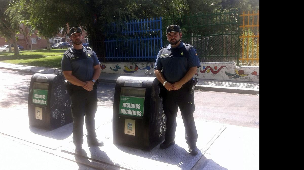 
Imagen cedida por la Guardia Civil de los dos agentes del instituto armado junto al contenedor de basura al que habia sido arrojado un bebé en Mejorada del Campo.
