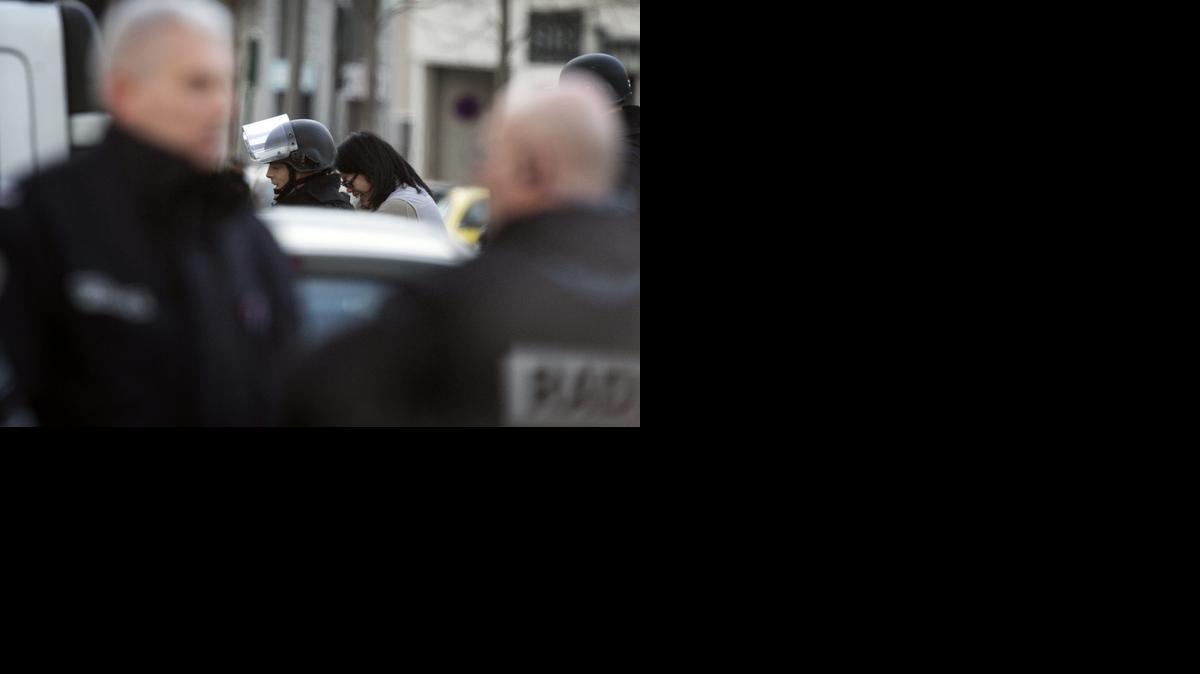 
Un agente de las fuerzas especiales de la policía francesa RAID escolta a una mujer después de que un hombre fuertemente armado tomara varios rehenes en una oficina de correos al oeste de París, en la localidad de Colombes (Francia) hoy, viernes 16 de enero de 2015. El ataque no tiene naturaleza terrorista, según la cadena local "BFM TV". EFE/Ian Langsdon
