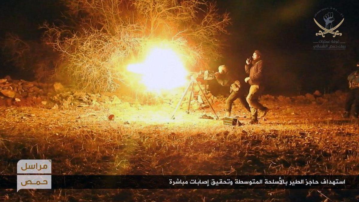 Extremistas del brazo de al-Qaida en Siria disparan una ametralladora de grueso calibre contra un puesto de control gubernamental en la provincia de Homs el jueves.