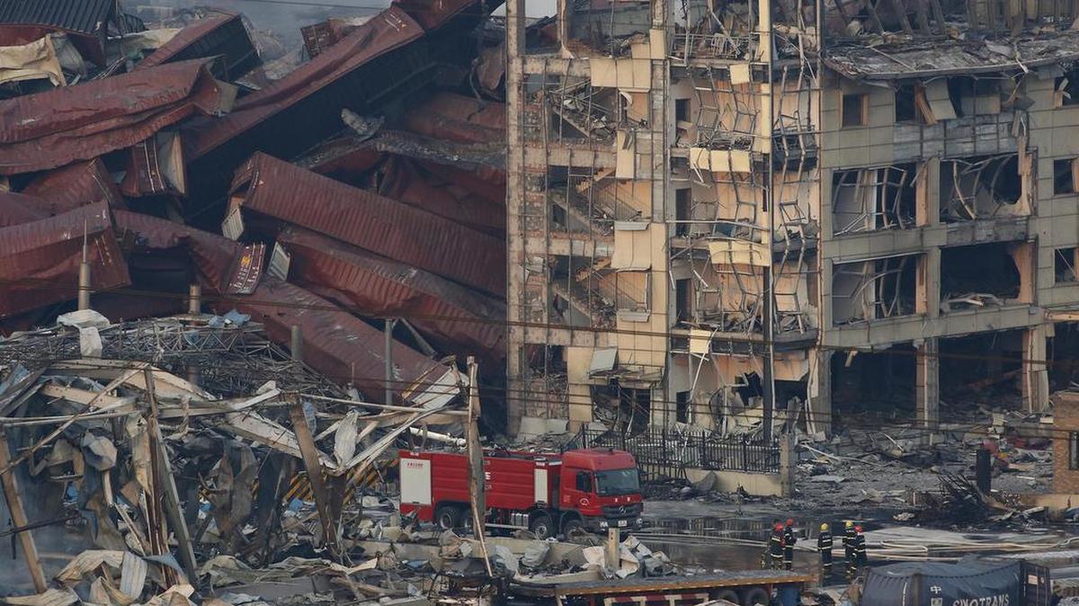 
Miembros de los servicios de rescate trabajan entre cientos de vehículos quemados y varios edificios destruídos tras varias explosiones en Tianjin, China, el jueves.
