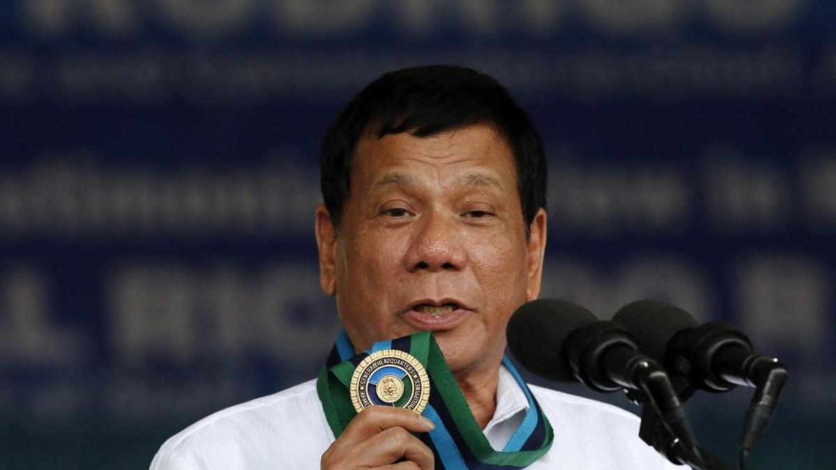 El presidente de Filipinas, Rodrigo Duterte, sostiene una medalla mientras pronuncia un discurso durante una ceremonia de cambio de mando en el cuartel militar de Quenzon, al este de Manila, Filipinas, el 7 de diciembre de 2016.