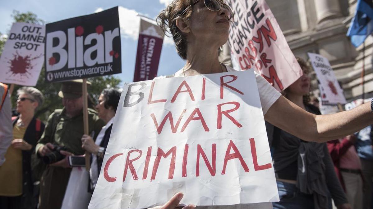 Numerosas personas participan en una protesta a la entrada del centro de conferencia Queen Elizabeth II, donde el exalto funcionario británico John Chilcot presentó un informe sobre la preparación y las consecuencias de la guerra de Irak, en el barrio de Westminster, en Londres, Reino Unido, Reino Unido, hoy, 6 de julio de 2016.