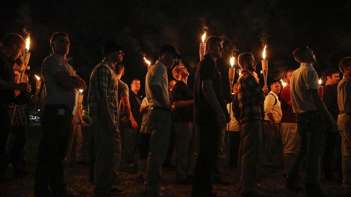 Varios grupos supremacistas blancos marchan con antorchas a través del campus UVA en Charlottesville, Virginia el 11 de agosto de 2017.