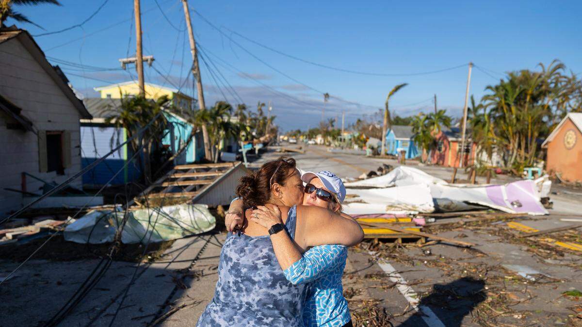 Donna LaMountain, de 51 años, abraza a su amiga Tammey Lynch, de 55, después de ver los daños en Pine Island Road el 29 de septiembre de 2022, en Matlacha, Florida. El huracán Ian tocó tierra en la costa del suroeste de la Florida como tormenta de categoría cuatro, dejando zonas con calles inundadas, árboles caídos y escombros esparcidos.