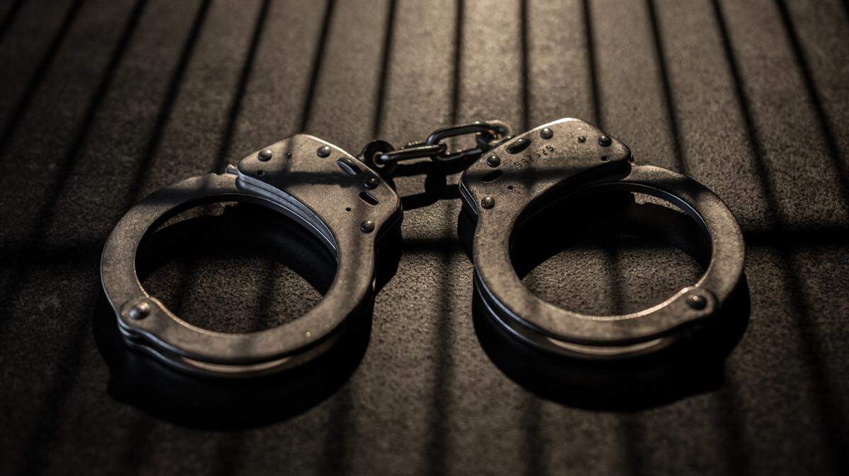 A man was arrested early Friday morning after authorities say he was found outside a Perry elementary school with a machete.