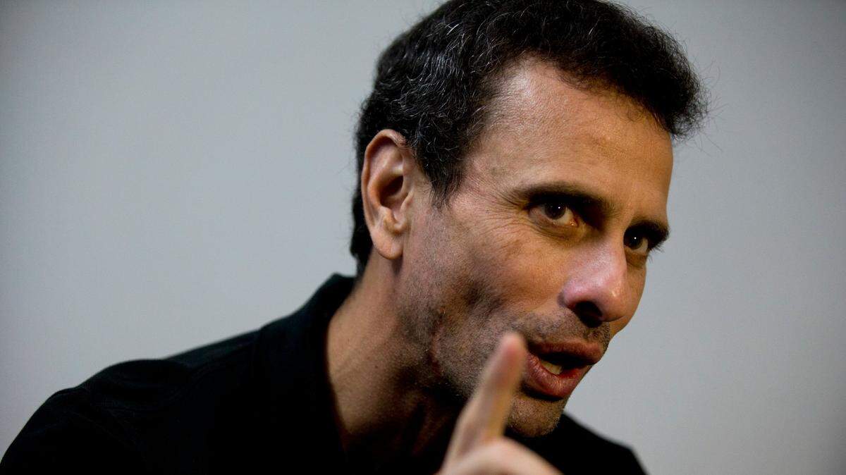 FILE - In this July 30, 2018 file photo, Venezuela’s opposition leader Henrique Capriles speaks during an interview at his office in Caracas, Venezuela. Capriles broke on Wednesday, Sept. 2, 2020, with U.S.-backed leader Juan Guaido, whose coalition has vowed to boycott the crisis-torn nation’s upcoming congressional elections claiming they’re rigged. (AP Photo/Fernando Llano, File)