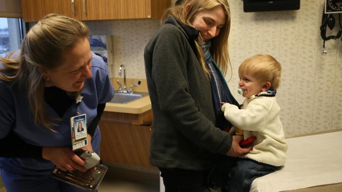 La enfermera Ann Brown (izq.) atiende a Landon Kuester, de 13 meses, en Centegra Physician Care, en Crystal Lake, Illinois.