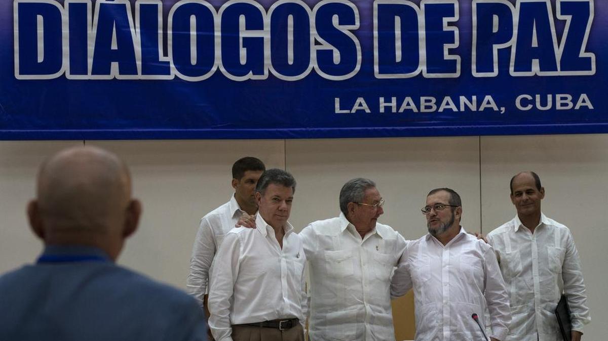 
El gobernante cubano Raúl Castro (centro), el presidente colombiano Juan Manuel Santos (izq.) y el jefe guerrillero Timoleón Jiménez se reúnen al anunciar un acuerdo en La Habana, el 23 de septiembre.

