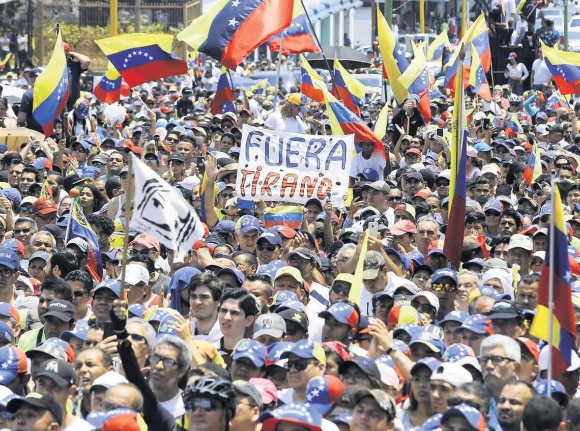 Supporters listen to Venezuelan opposition leader and self-proclaimed interim president Juan Guaidó during a rally in Valencia, Carabobo State, Venezuela, on March 16, 2019.