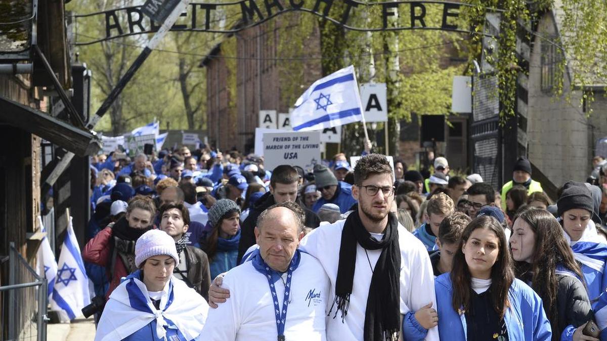Participantes de la Marcha de los Vivos entran en el antiguo campo de concentración de Auschwitz-Birkenau, en Polonia, este lunes, recordando a las víctimas del Holocausto.