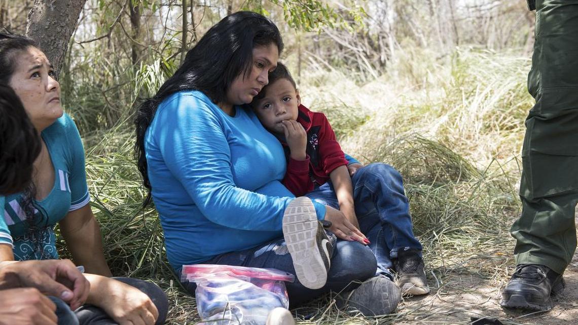 Keilyn Enamorada Matute, from Honduras, with her 4-year-old son, as they surrender themselves to Border Patrol agents after crossing the Rio Grande from Mexico to the United States, in McAllen, Texas.
