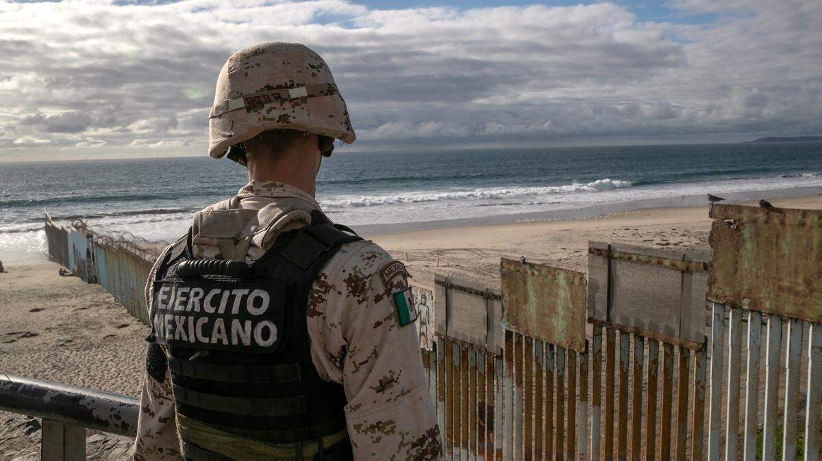 A Mexican soldier looks over border fence with the United States on September 28, 2019 in Tijuana, Mexico.