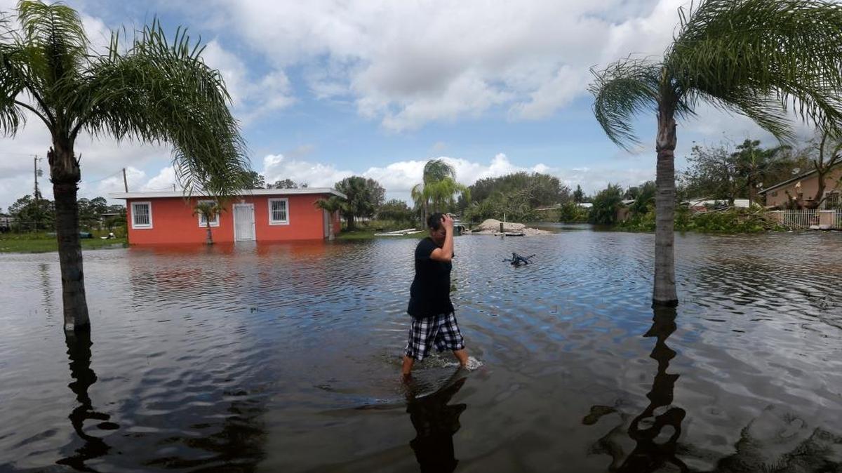 Julie Robles cruza un vecindario inundado en Immokalee, Florida, después del azote del huracán Irma.