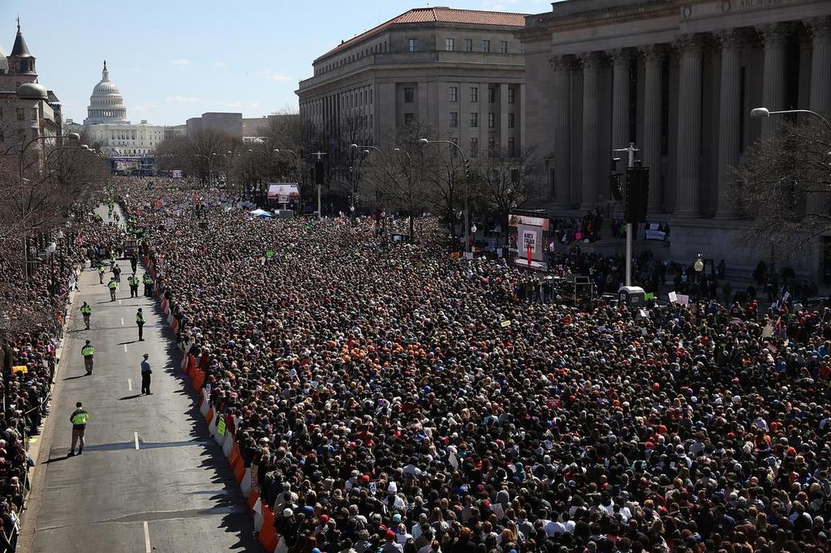 Hundreds of thousands attend the march to demand tighter control of arms sales, on Saturday in Washington D.C. The protest was organized by the students who survived the killing at Stoneman Douglas High School.